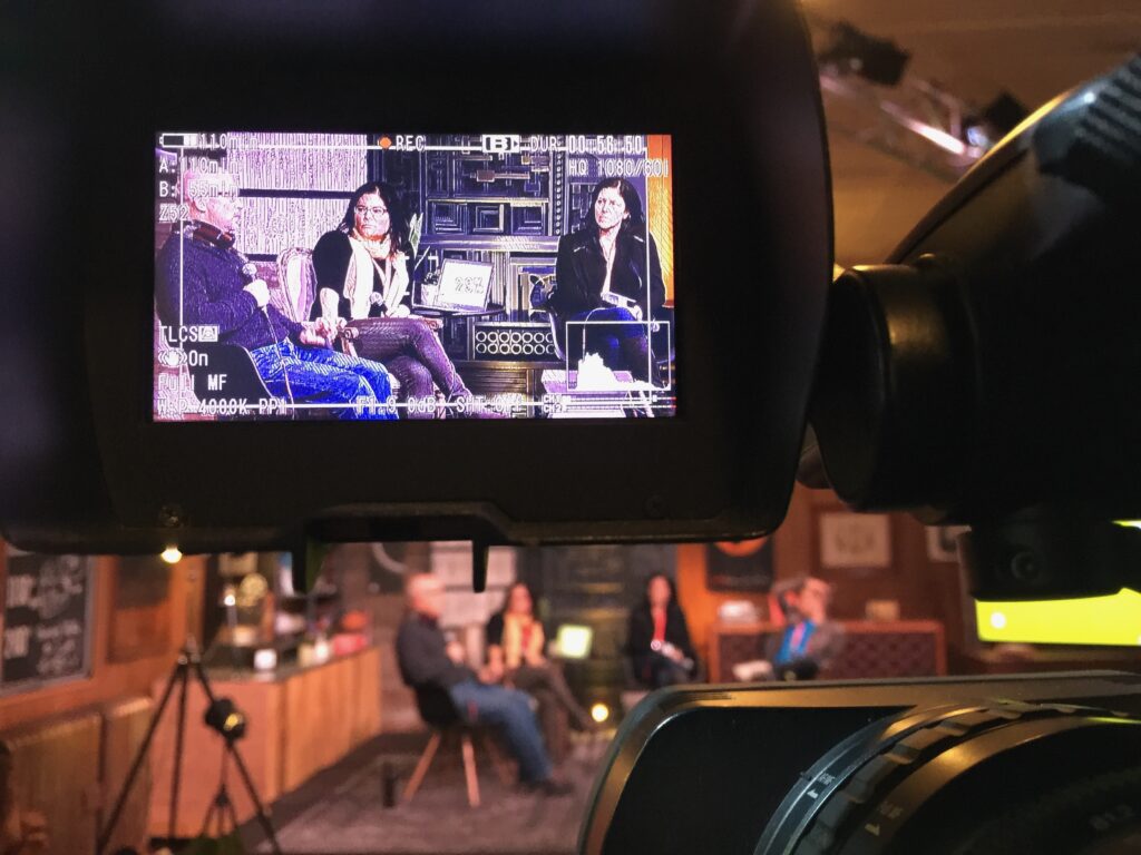 Image of a camera viewfinder recording a forum discussion at the 2015 Sundance Film Festival.
